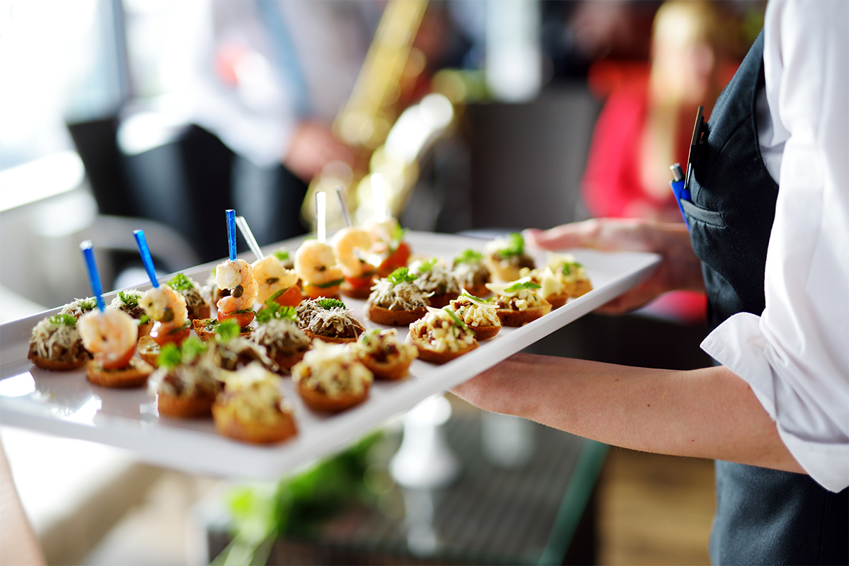 Waitress serving appetizers on tray